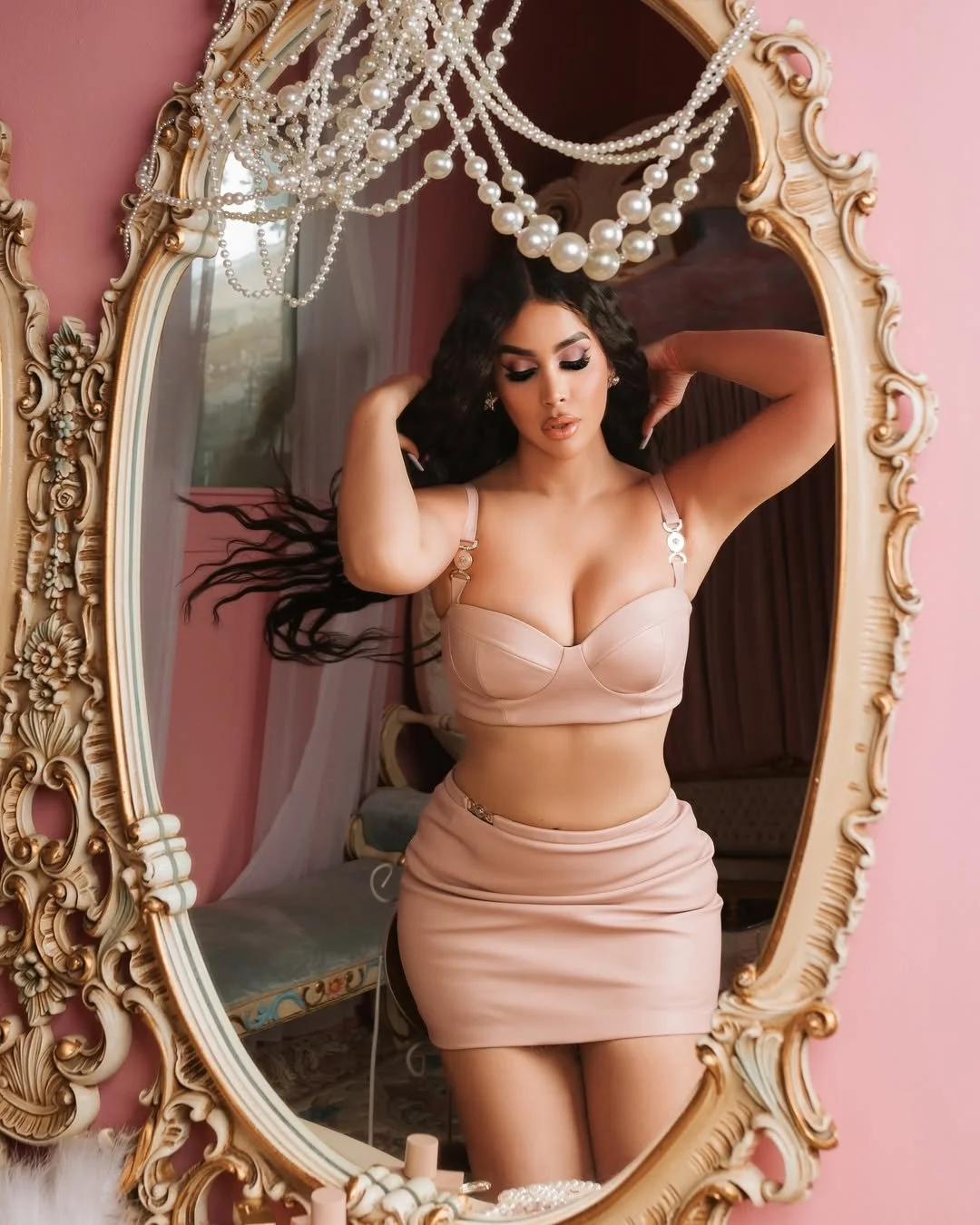 Olivia Jade posing in an ornate mirror framed with pearls
